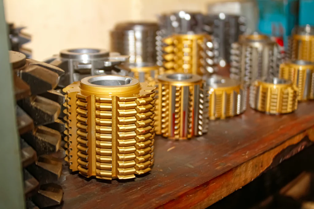 Tools and parts used in CNC machining of brass - manufacturing precision wheels and components.