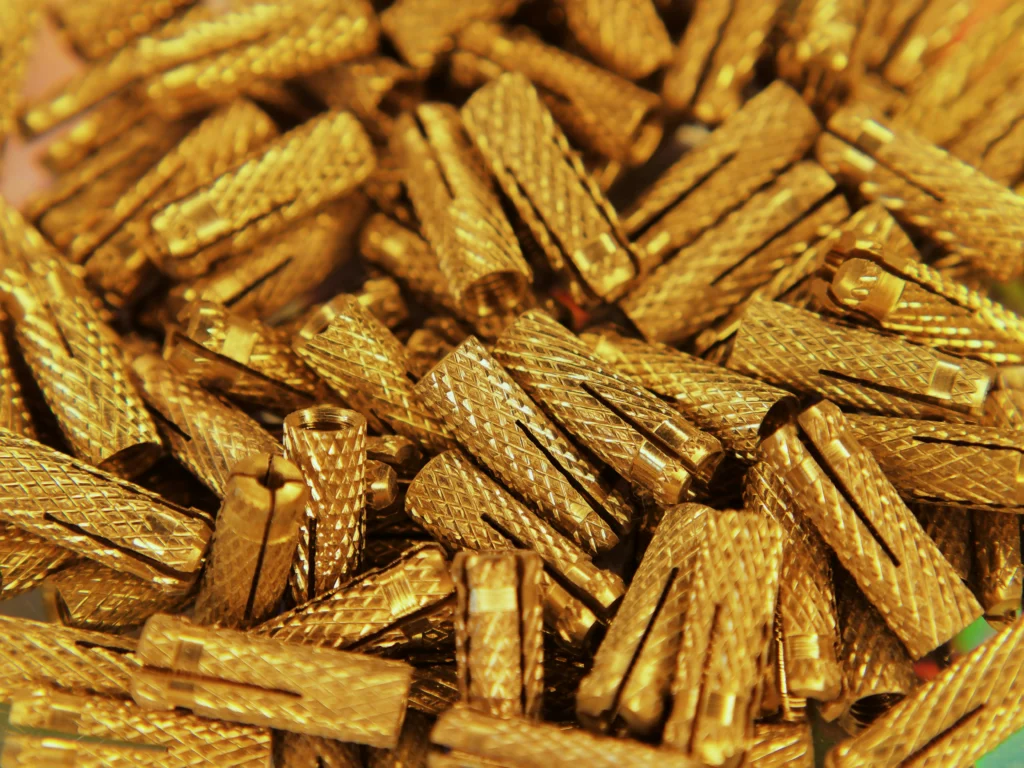 Precision parts made by CNC machining of brass - details ready for installation in mechanical components.