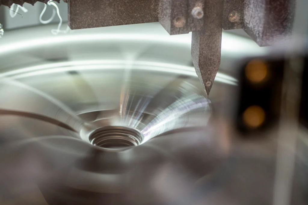 Surface finishing of a metal component during CNC machining